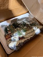 Village display in Styrofoam packaging inside box