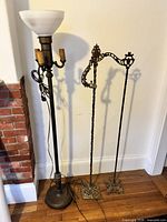 Overall view of torchiere lamp and two cast iron stands