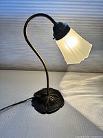 Side view of brass table lamp illuminated