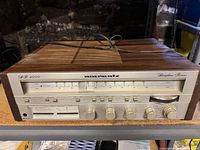 Front view showing tuner scale, knobs, wood cabinet