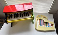 Toy piano and plastic xylophone on table