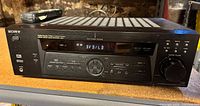 Front view of Sony STR-DE475 receiver with remote on top