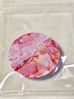 Front view of pink marble phone grip in pouch