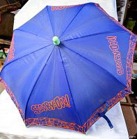 Open blue umbrella showing orange Scooby-Doo graphics and green tip