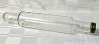 Full view of clear glass rolling pin showing length and shape