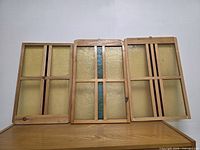Front view of three stained glass frames standing side by side