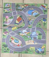 Play mat with roads, gas station and car wash graphics