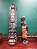 Full view of both wooden carvings on shelf