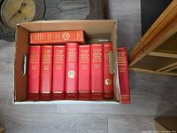 Box of ten red Champlain Society hardcovers showing spines with titles and publication years