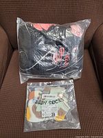 Overall shot of sealed baby blanket and packaged baby socks