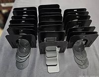 Front view of all 23 black metal bookends with their bases