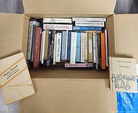 Open box showing all books and two volumes outside
