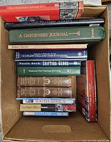 Open box showing spines and covers of approximately twelve nonfiction books