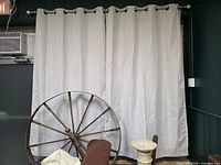 Front view of two grey blackout curtain panels hanging on metal rod
