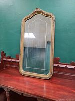 Front view of decorative mirror showing full frame and glass