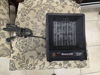 Front view of Honeywell ceramic heater showing mesh grille and brand badge