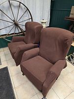 Two matching recliner chairs with brown covers, front view upright