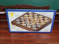 Front of retail box showing wooden board and metal pieces