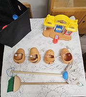 Overview showing Mr. Potato Head bodies, Little People store, toy broom and mop, fabric bin