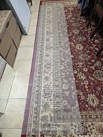 Full view of clear plastic runner laid over patterned rug showing length and ribbed texture