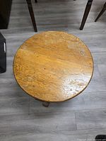 Top view of wooden circular table showing surface condition