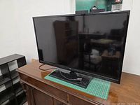 Front view of RCA flat screen TV on stand