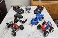 All seven toy cars arranged on tabletop
