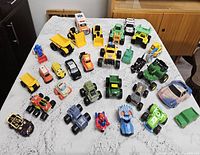 Overview of all plastic toy vehicles spread on tabletop