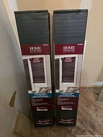 Two unopened boxes of Home Decorators Collection brown 36 × 72 in window blinds
