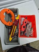 Overall lot with fish tape, surform, hacksaw, pliers, caddy and bin
