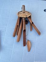 overview of bamboo wind chime with six tubes, woven top, clapper and sail visible