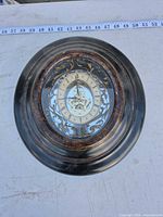 Front view of Bombay & Co. ornate wall clock showing dial and design