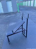 Side view of adjustable bench showing padded backrest, seat and upright bar supports