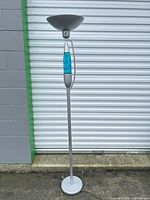 Full view of floor lamp showing base, pole, blue accent section, shade