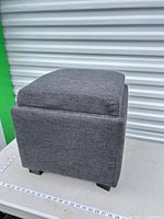 Front view of gray storage ottoman