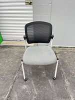 Front view showing mesh back, fabric seat, caster legs