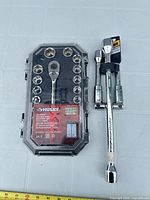 Full view of socket set in case and breaker bar with sockets