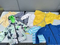 Overview of six toddler garments laid on table