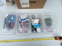 Overview of four storage trays filled with bead supplies