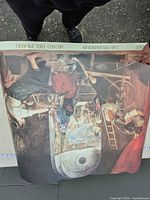 Rolled poster partially unrolled showing Las Hilanderas image and Museo del Prado header