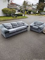 Front view of sofa and armchair showing style, upholstery color and wear