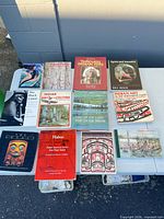 Overhead view of all twelve Indigenous art and culture books laid out on a table