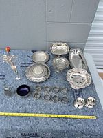 Group shot of all silver-plated serving pieces, napkin rings and shakers
