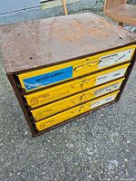 Front and top view of metal cabinet showing five yellow drawers