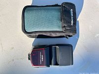 Minolta Program 3500xi flash beside Case Logic pouch