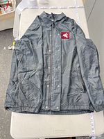 Full jacket front view showing color, pattern, patch, closure