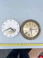 Front view of both clocks showing designs and faces