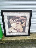 Full view of framed wall art leaning against wall