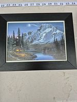 Front view of one framed print showing mountain landscape