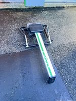 Full view of rowing machine folded on pavement